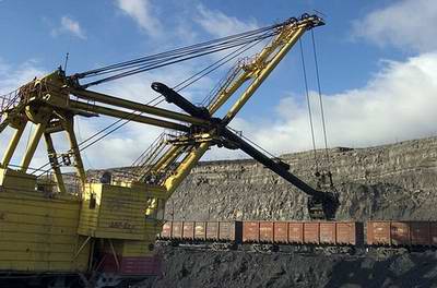 Kazakhstan coal industry - Ekibastuz open pit coal mine excavator scooping coal into trains photo